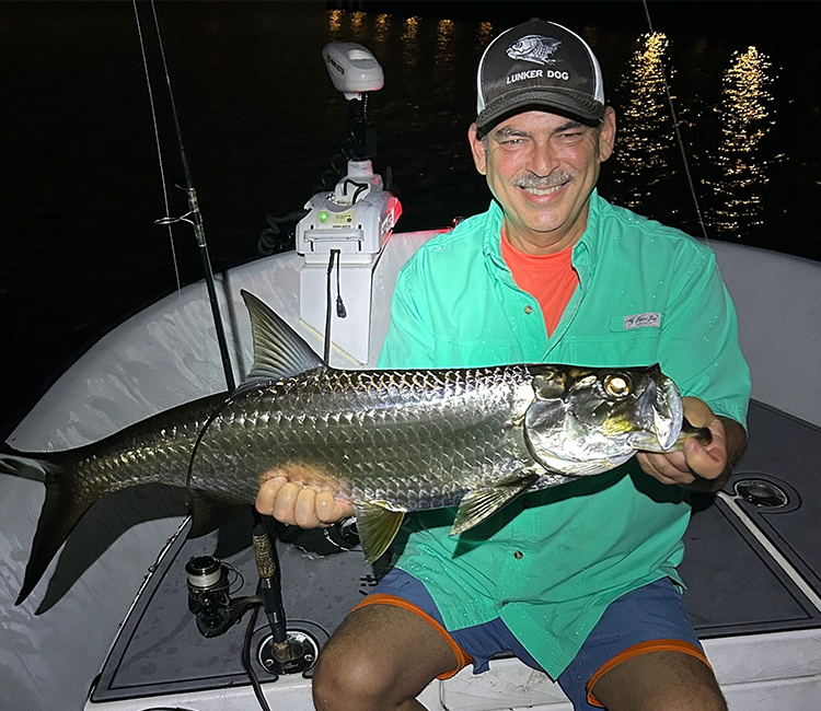 Angler holding a catch aboard a boat in Fort Lauderdale