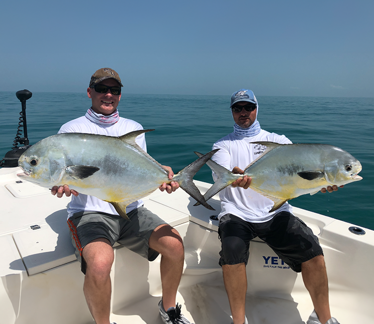 Two fishermen with their catch on a Lunkerdog charter