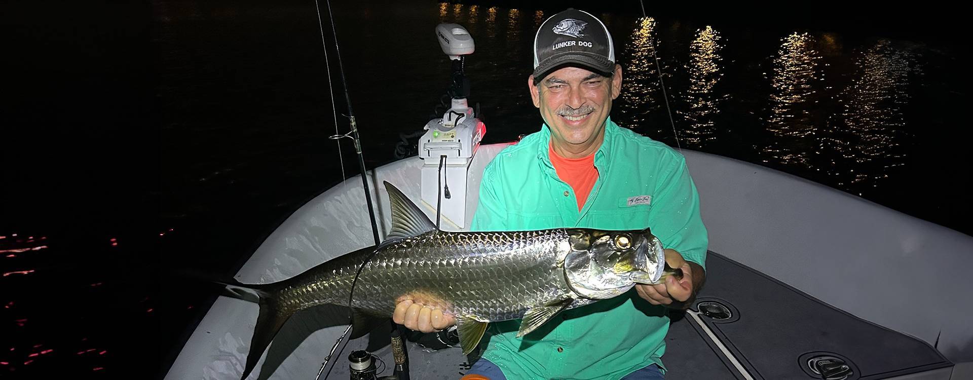 Angler holding a catch aboard a boat in Fort Lauderdale