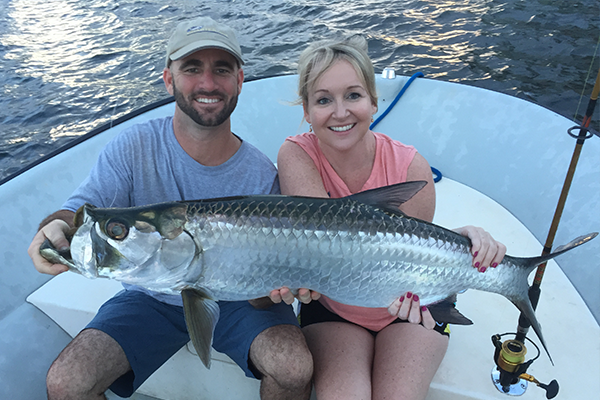 Two fishermen celebrating a catch in Boca Raton