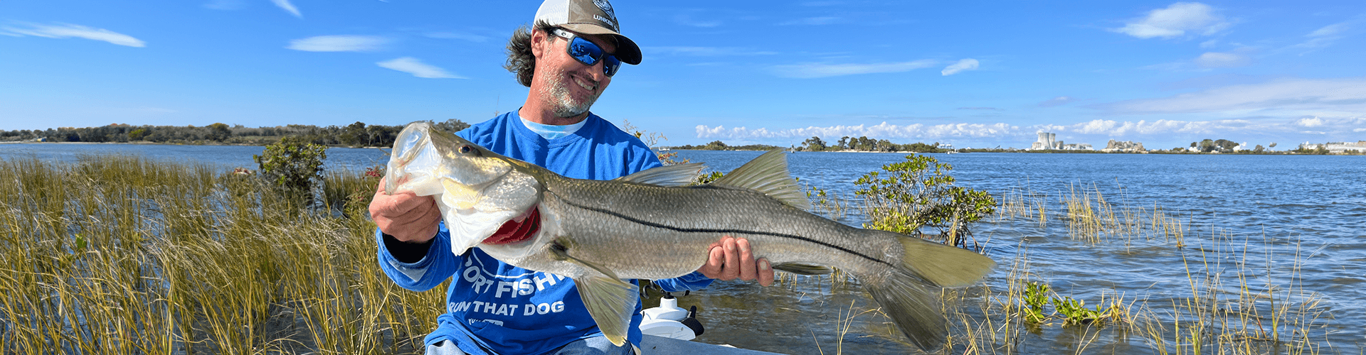 Captain Jeff in the water with a catch near Miami