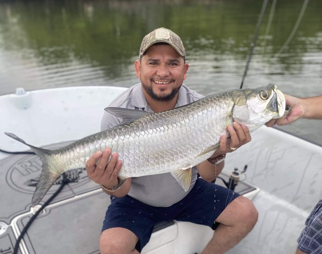 Fisherman proudly displaying two catches in Miami