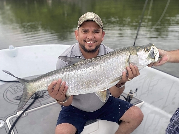 Fisherman proudly displaying two catches in Miami