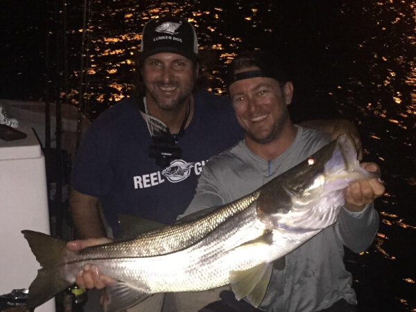 Fisherman with a catch during a Miami charter