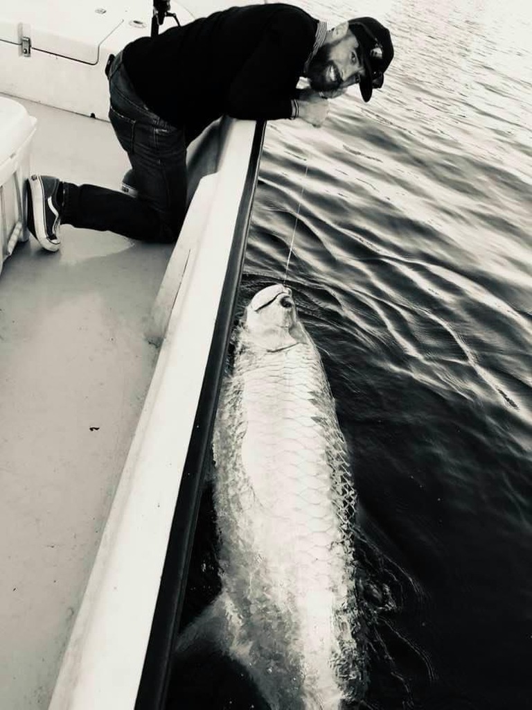 Fisherman in stylish attire fishing on a boat in Hollywood