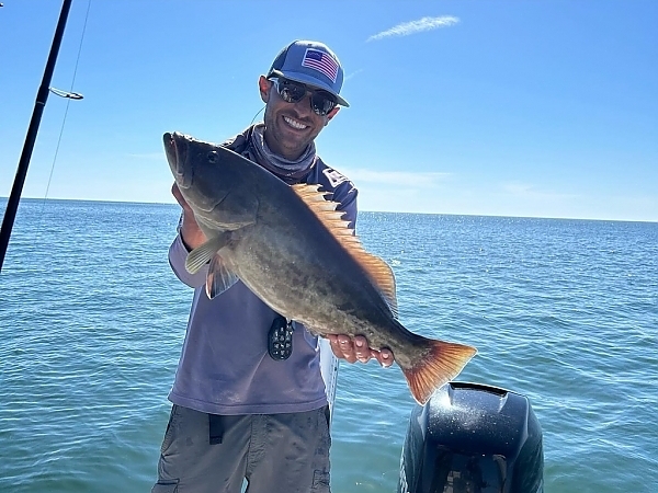 Angler with a catch aboard a boat in Boca Raton