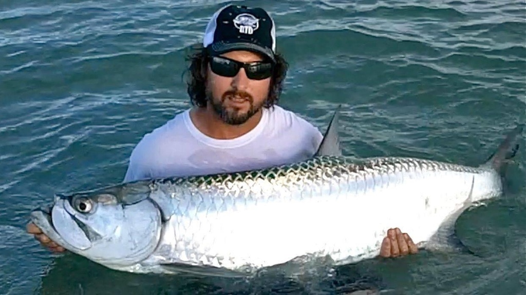 Fisherman displaying two large catches near Miami