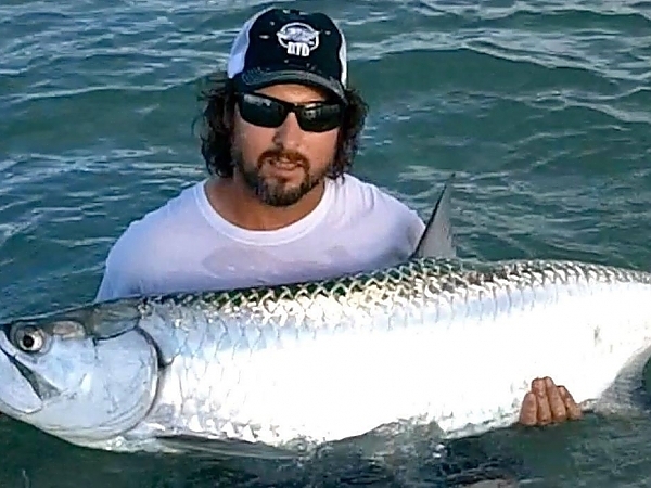 Fisherman with a catch aboard a Lunkerdog charter in Boca Raton