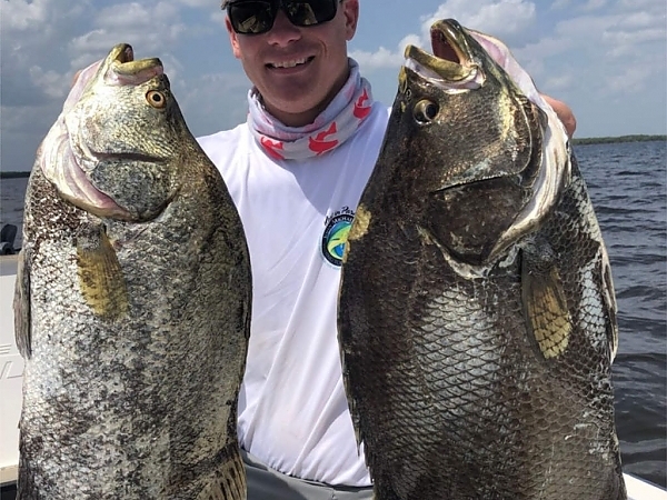 Fisherman with a catch during a Miami fishing trip