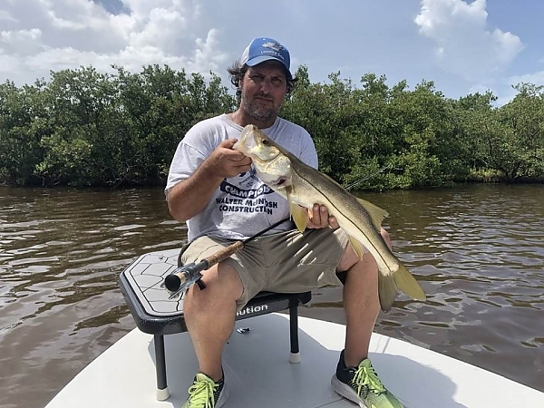 Fisherman proudly holding a catch in Boca Raton