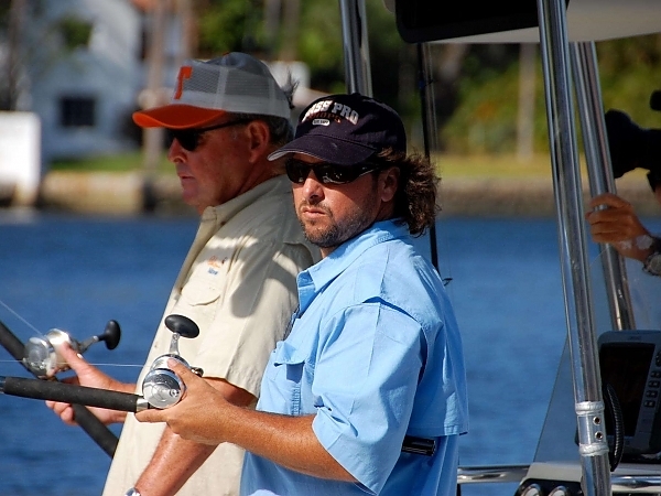 Angler in a boat showing a catch in Fort Lauderdale