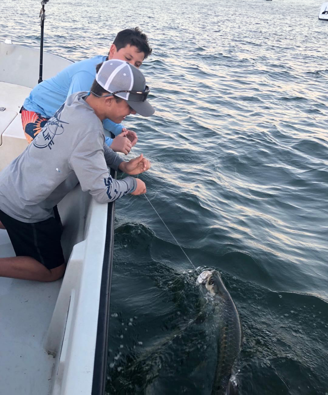 Angler with a catch at a vibrant Fort Lauderdale sunset