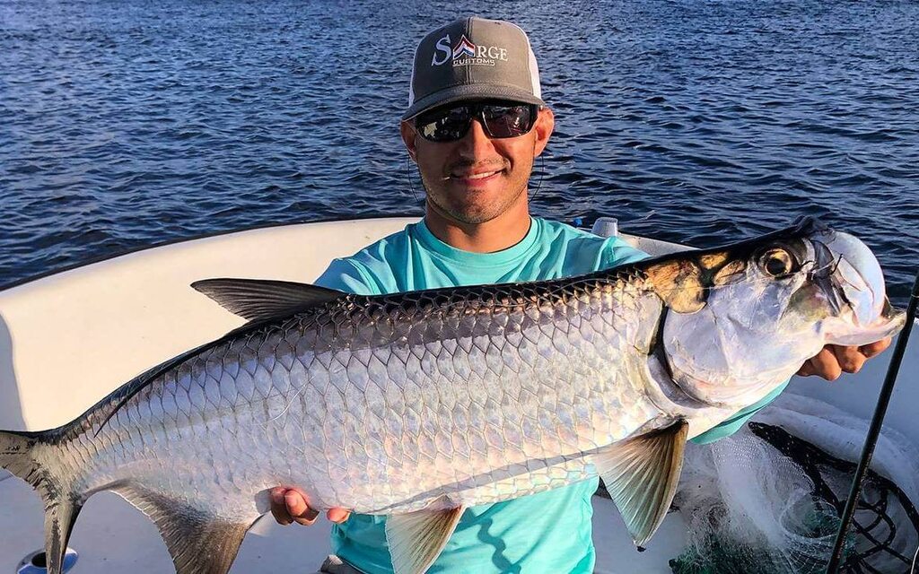 Fisherman with a catch during a sunset in Boca Raton