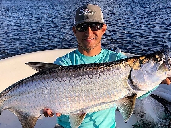 Fisherman with a catch during a sunset in Boca Raton